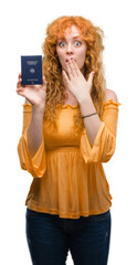 Poster - Young redhead woman holding passport of Germany cover mouth with hand shocked with shame for mistake, expression of fear, scared in silence, secret concept