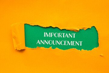 Important announcement words written on torn orange paper with green background. Conceptual important announcement  symbol. Copy space.