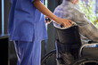 © peopleimages.com - Wheelchair, caregiver and senior person with disability for support, caring and homecare for old people. Healthcare, elderly man and nurse for helping, assistance and retiree with medical worker