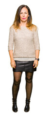 Wall Mural - beautiful middle age woman wearing fashion sweater relaxed with serious expression on face. simple a