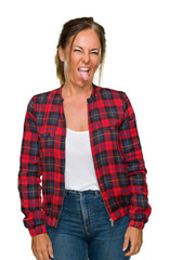 Wall Mural - Middle age adult woman wearing casual jacket over isolated background sticking tongue out happy with funny expression. Emotion concept.