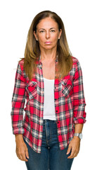 Wall Mural - middle age adult woman wearing casual shirt over isolated background with serious expression on face