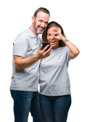 Wall Mural - middle age hispanic couple texting message on smartphone ver isolated background with happy face smi