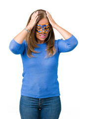 Wall Mural - Beautiful middle age woman wearing venice carnival mask over isolated background suffering from headache desperate and stressed because pain and migraine. Hands on head.