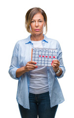 Wall Mural - middle age senior hispanic woman holding menstruation calendar over isolated background with a confi