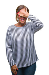 Canvas Print - Middle age senior hispanic woman over isolated background smiling and laughing with hand on face covering eyes for surprise. Blind concept.