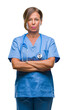 © Krakenimages.com - Middle age senior nurse doctor woman over isolated background skeptic and nervous, disapproving expression on face with crossed arms. Negative person.