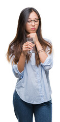 Sticker - Young asian woman drinking a glass of water over isolated background serious face thinking about question, very confused idea