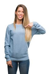 Poster - Beautiful young woman wearing sweater and jeans with surprise face pointing finger to himself