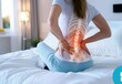 © Stocks Buddy - A woman with back pain holding her lower right side of the spine in bed