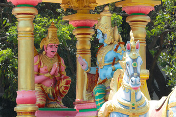 arjuna and krishna on a chariot. indian religious temple sculpture.