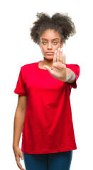 Sticker - Young afro american woman over isolated background doing stop sing with palm of the hand. Warning expression with negative and serious gesture on the face.