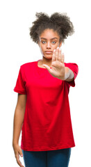 Canvas Print - Young afro american woman over isolated background doing stop sing with palm of the hand. Warning expression with negative and serious gesture on the face.