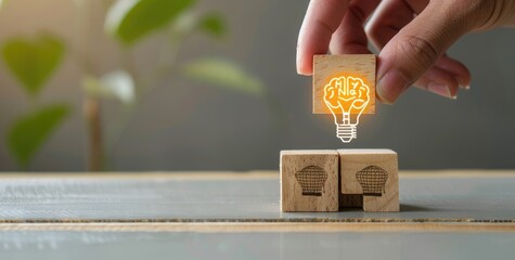 Hand placing wooden block with light bulb and human head icons on table, symbolizing creative thinking or idea concept. High quality photo of hand picking cube from pile isolated on grey background.