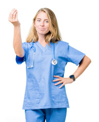 Wall Mural - Beautiful young doctor woman wearing medical uniform over isolated background Doing Italian gesture with hand and fingers confident expression