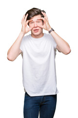 Wall Mural - Young handsome man wearing casual white t-shirt over isolated background Trying to open eyes with fingers, sleepy and tired for morning fatigue