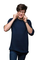 Wall Mural - Young handsome man wearing glasses over isolated background covering ears with fingers with annoyed expression for the noise of loud music. Deaf concept.