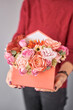 Box in the form of an post envelope of a letter. Small Beautiful bouquets of mixed flowers in woman hand. Floral shop concept . Beautiful fresh cut bouquet. Flowers delivery