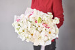 Large Beautiful bouquets of mixed flowers in woman hand. Floral shop concept . Beautiful fresh cut bouquet. Flowers delivery