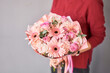 Small Beautiful bouquets of mixed flowers in woman hand. Floral shop concept . Beautiful fresh cut bouquet. Flowers delivery