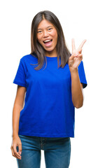 Wall Mural - Young asian woman over isolated background smiling with happy face winking at the camera doing victory sign. Number two.