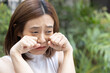 Young female’s tear, sad unhappy failed and frustrated young East Asian woman crying, weeping, sobbing with failure