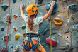 Cheerful school girl climbing high indoor rock wall in gym.