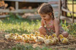 Adorable little girl playing with ducklings outdoors