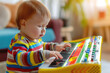 Adorable little toddler playing with toy piano. Early development and learning music