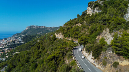 view of rich city of Montecarlo, tall buildings, narrow streets famous for formula 1 race. mountain, sea and beautiful city on a sunny day vacation and tourism in rich city with yachts and luxury cars