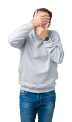 Wall Mural - Handsome middle age senior man wearing a sweatshirt over isolated background Covering eyes and mouth with hands, surprised and shocked. Hiding emotion