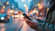© SUYATI - A man holds a mobile phone in his hands, a close-up image of a man looking at his smartphone. Colorful blurred futuristic bright background, city lights bokeh effect