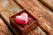 A sweet pink heart in a box with chocolate candies. Love concept.