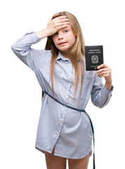 Poster - Young blonde toddler holding italian passport stressed with hand on head, shocked with shame and surprise face, angry and frustrated. Fear and upset for mistake.