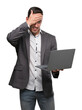 © Krakenimages.com - Handsome young man using computer laptop stressed with hand on head, shocked with shame and surprise face, angry and frustrated. Fear and upset for mistake.