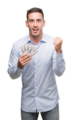 Sticker - Handsome young man holding money screaming proud and celebrating victory and success very excited, cheering emotion