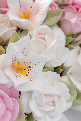 Wall Mural - Zephyr bouquet of flowers in a wicker basket on a light background