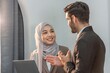 © BESTIMAGE - Asian muslim woman assistant secretary discussion examining in inspection check data in tablet notebook with boss manager. Boss and muslim woman partnership talking check successful data in laptop.