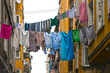 Variations of different clothes drying on rope in a city street