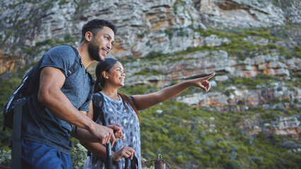 Wall Mural - Couple, happy and pointing to mountain for hiking in forest with backpack, adventure and morning workout for summer fitness. People, trail walk and exercise, training and explore in nature for cardio