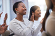 © peopleimages.com - Woman, smile and applause in meeting for success, achievement and celebration for presentation, goals or team building. Group, people and happy, good news or promotion, support or winner at seminar
