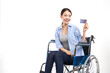 young asian women with happy smiling and show credit card sitting in a wheelchair on white background, healthcare concept, accident, insurance, life insurance, wellness, hospital.