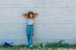 © carballo - relaxed latin girl leaning on street wall outdoors