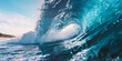 A large, powerful wave with blue water and clear sky in the background