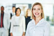 © peopleimages.com - Businesswoman, portrait and team leadership with smile or employee confident, collaboration or start up. Female person, face and coworkers for company about us at broker agency, goals or professional