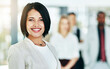 © peopleimages.com - Businesswoman, portrait and team leadership in office or employee confidence, collaboration or start up. Female person, face and coworkers for company about us at broker agency, goals or professional