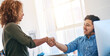© peopleimages.com - Business people, man and woman with handshake, call center and telemarketing with promotion. Modern office, coworkers and employees shaking hands, computer and agreement with support and thank you