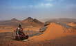 Buddhist monk meditating in the desert
