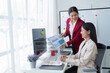 © Tj - Happy Asian smiling businesswoman working together in office