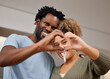 © peopleimages.com - Couple, fingers and heart with key in new home for real estate, smile with happiness in marriage. People, closeup and hands for gesture of love in house or apartment, mortgage or loan for investment